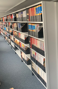 Zeitschriften stehen in einem Bibliotheksregal. 